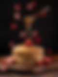 Food Photography of Stack of fluffy pancakes with fresh strawberries and honey drizzle on a wooden board