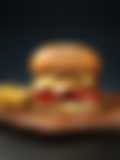 A juicy cheeseburger on a wooden cutting board, served with a side of golden french fries