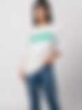 A woman wearing a white T-shirt with green ‘TALENTED’ lettering, paired with jeans, on a neutral background, showcasing a casual style.