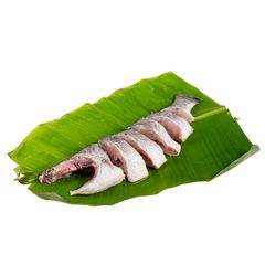 A mustard-marinated fish fillet on a banana leaf in a clay plate, garnished with a green chili, served alongside turmeric rice and a small bowl of sauce.
