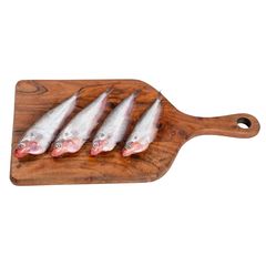 Five raw shrimp arranged on a white background, showcasing fresh seafood ready for cooking.