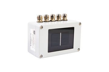 A small, weatherproof enclosure housing a solar sensor with four terminal connectors.
