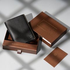A premium black leather wallet showcased in a branded gift box, highlighting handcrafted quality and elegant design.